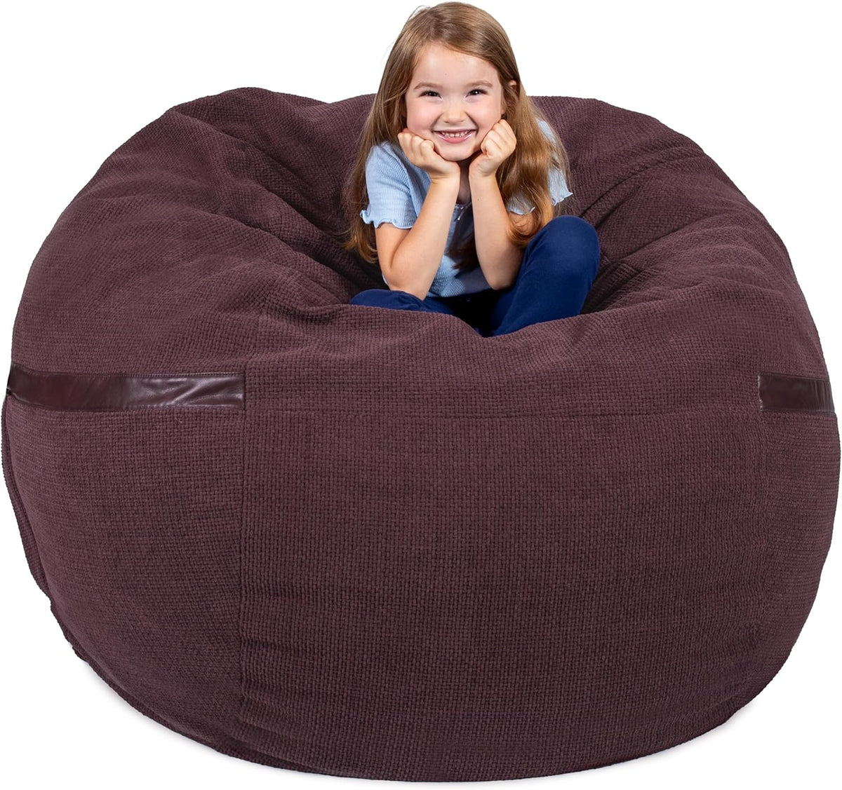 Young girl perched inside a deep plum textured bean bag, smiling at camera
