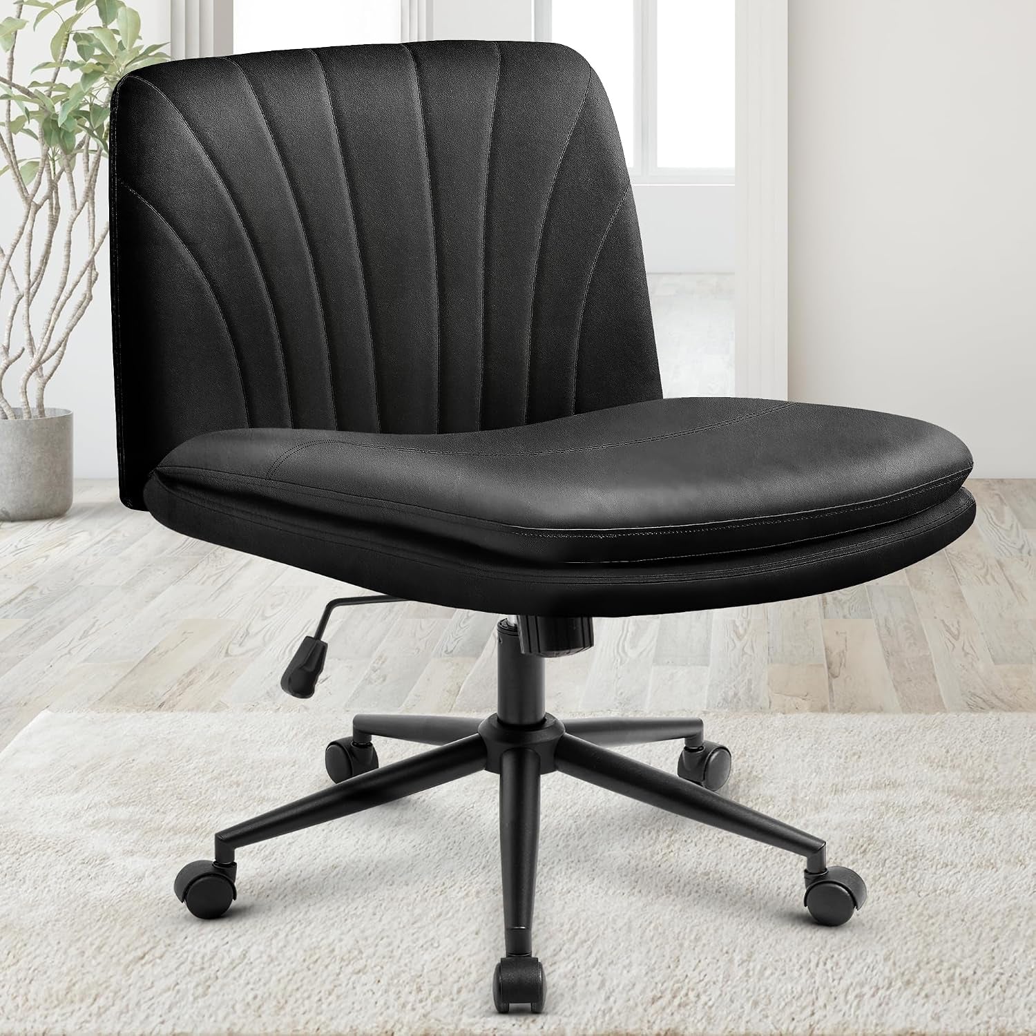 Black upholstered swivel desk chair with channel-tufted back and five-star caster base.