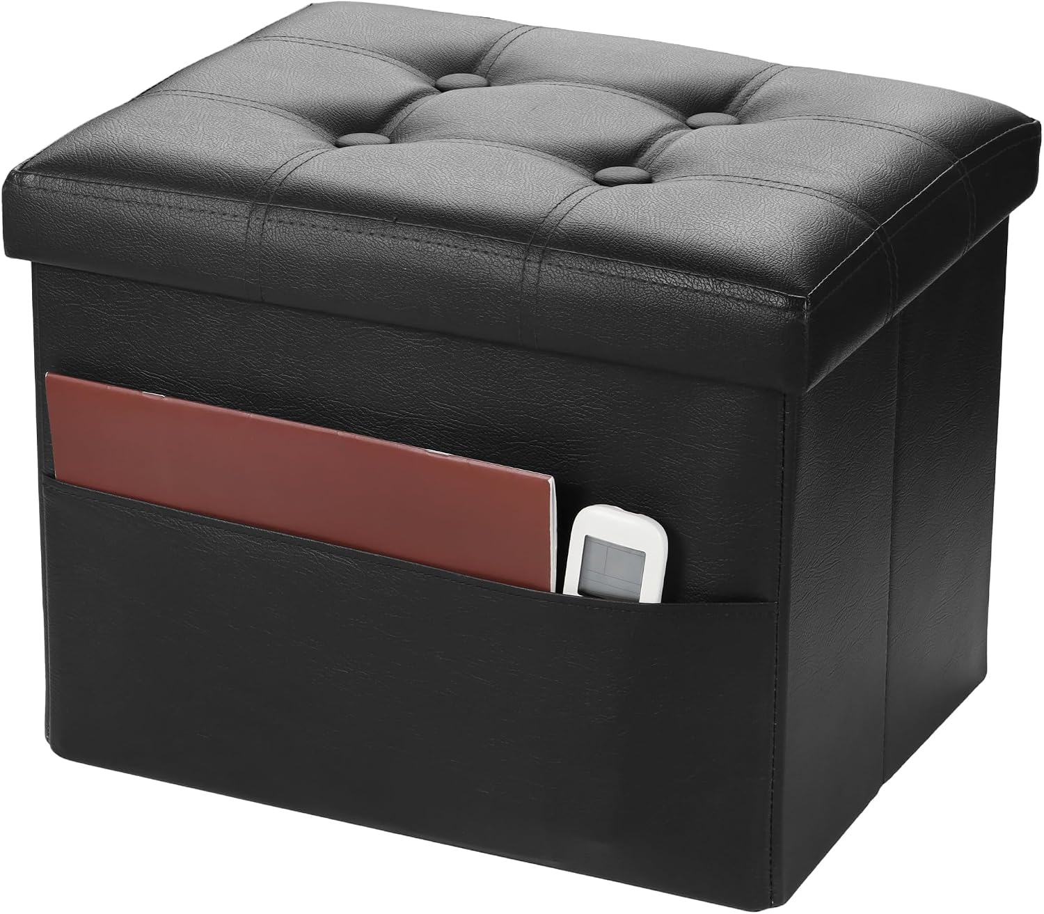 Black faux-leather storage ottoman at an angle showing tufted lid and front pocket with folder and remote