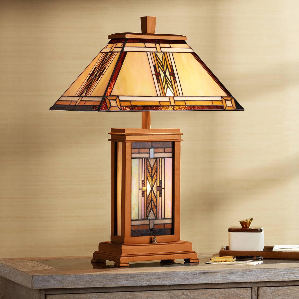 Lit Tiffany-style stained-glass shade and walnut-finish base shown on a desk, angled view