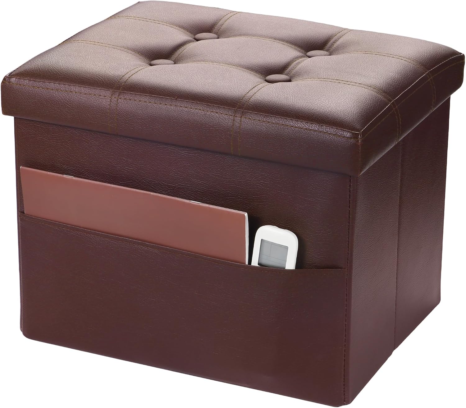 Brown faux-leather storage ottoman with button-tufted top and front pocket holding a book and remote