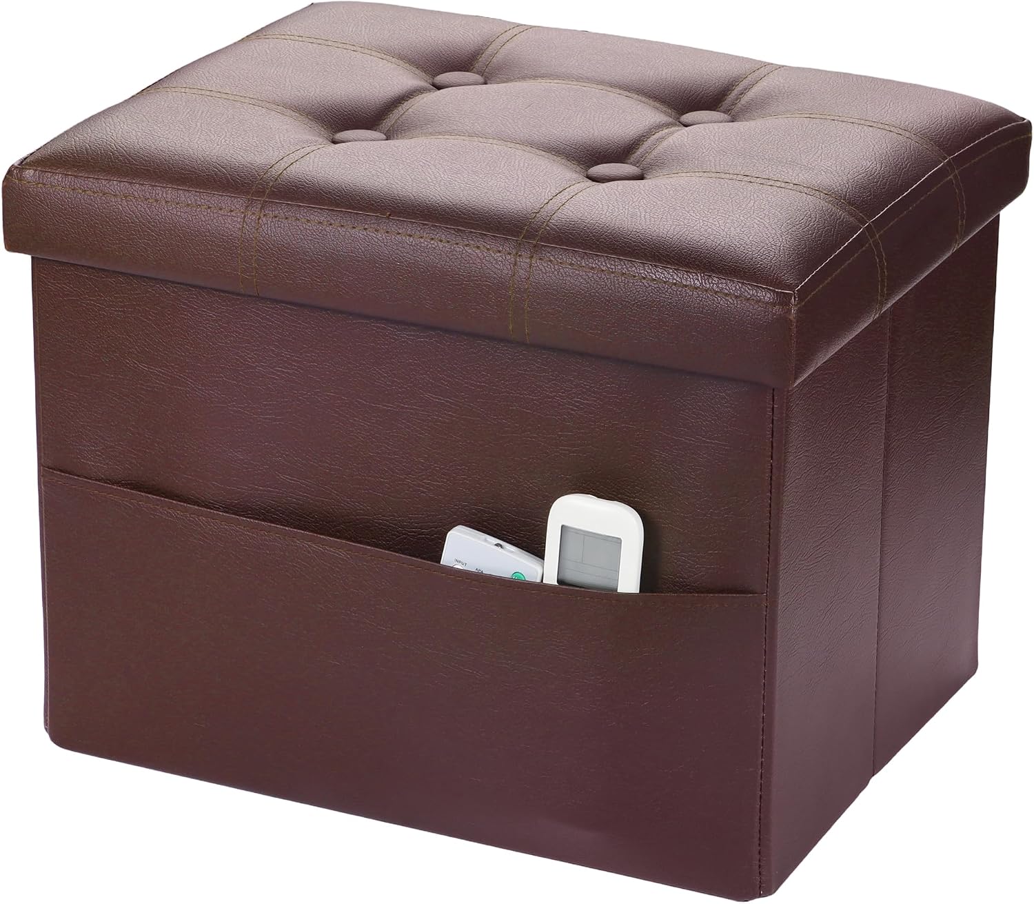 Brown faux-leather storage ottoman with tufted top and a side pocket holding remote controls.