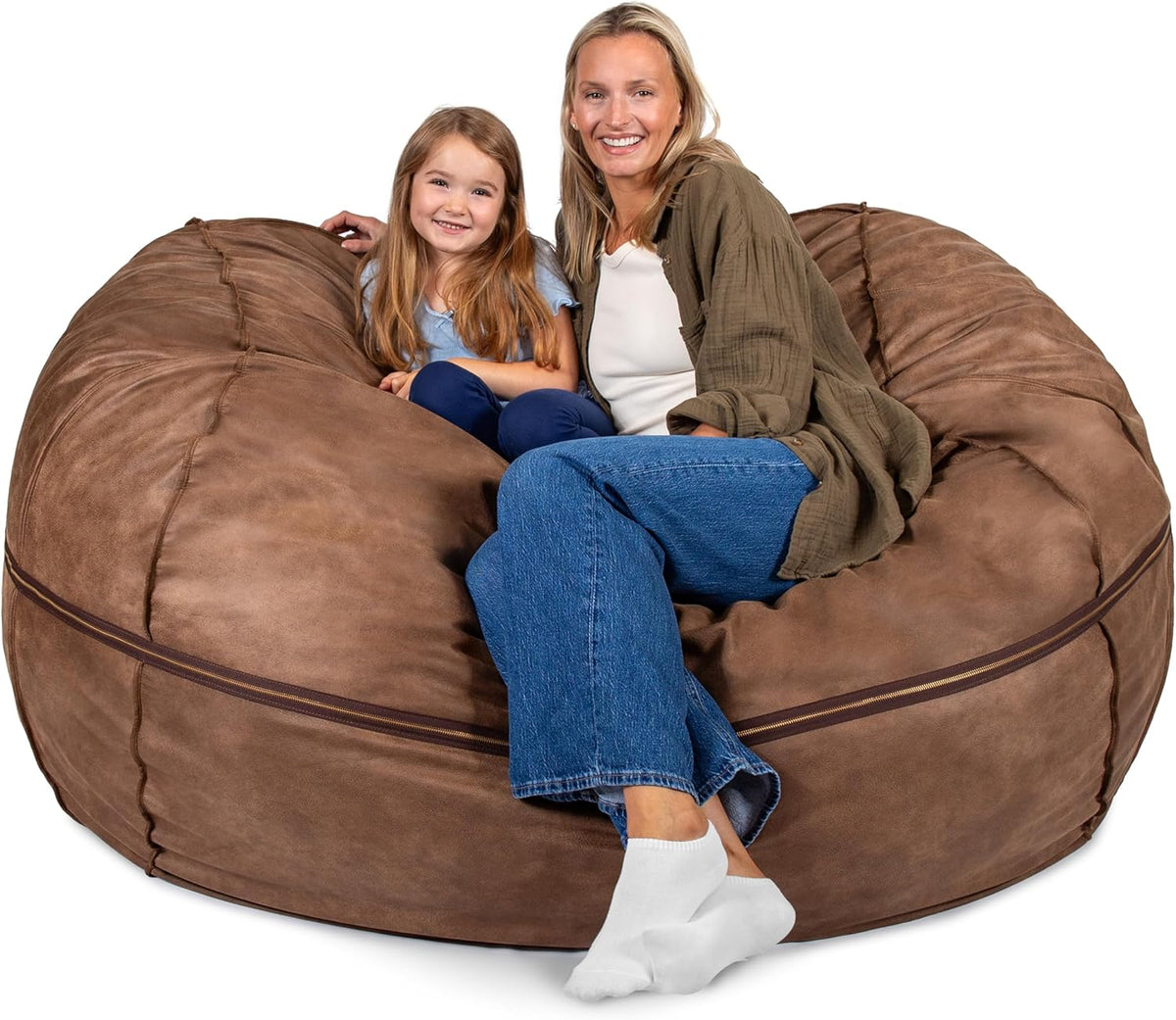 Woman and young girl seated on a large brown round lounger with a visible zipper seam around its middle.