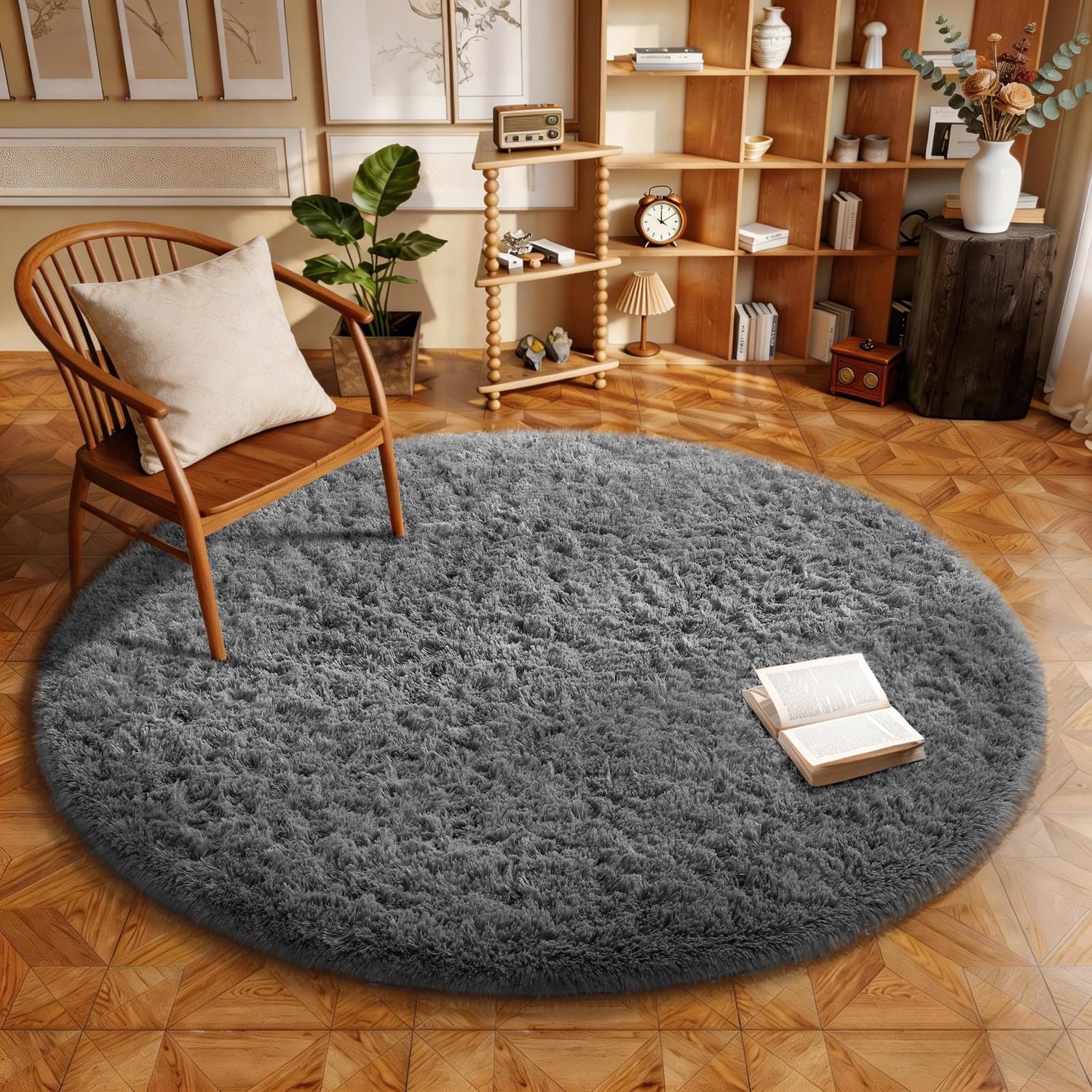 Round plush gray rug in a cozy room with a wooden chair, shelving and an open book on the rug