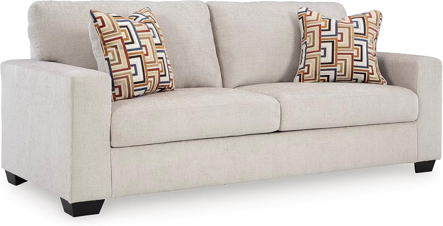 Stone chenille 85-inch sofa three-quarter view on a white background with two patterned accent pillows