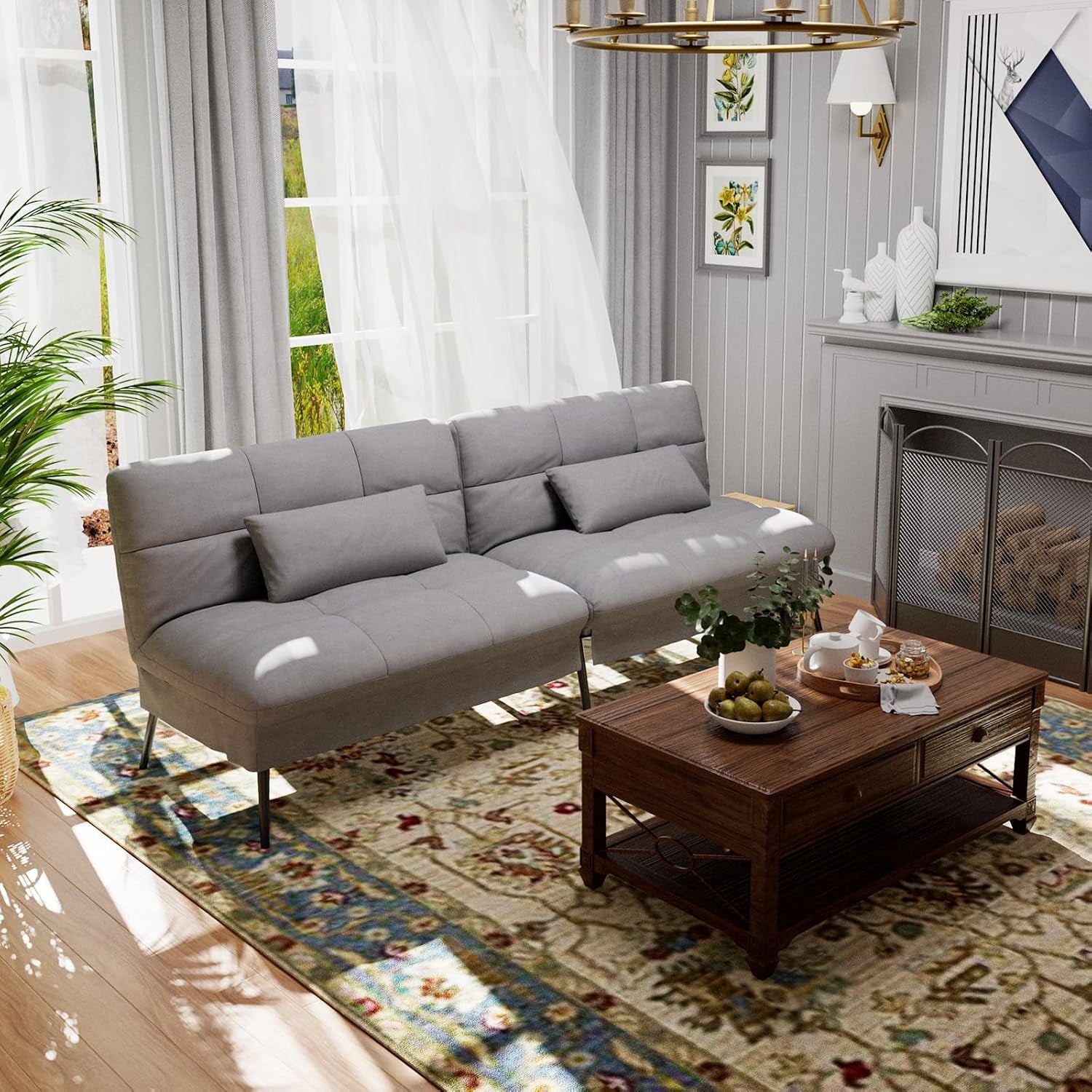 Styled living room scene with grey futon sofa set up as a three-seat sofa beside a coffee table