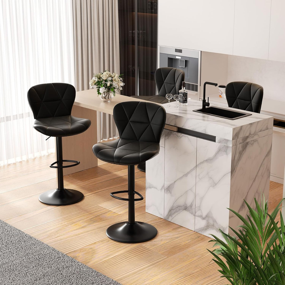 Three black bar stools around a breakfast island with a vase of flowers and a built-in sink.