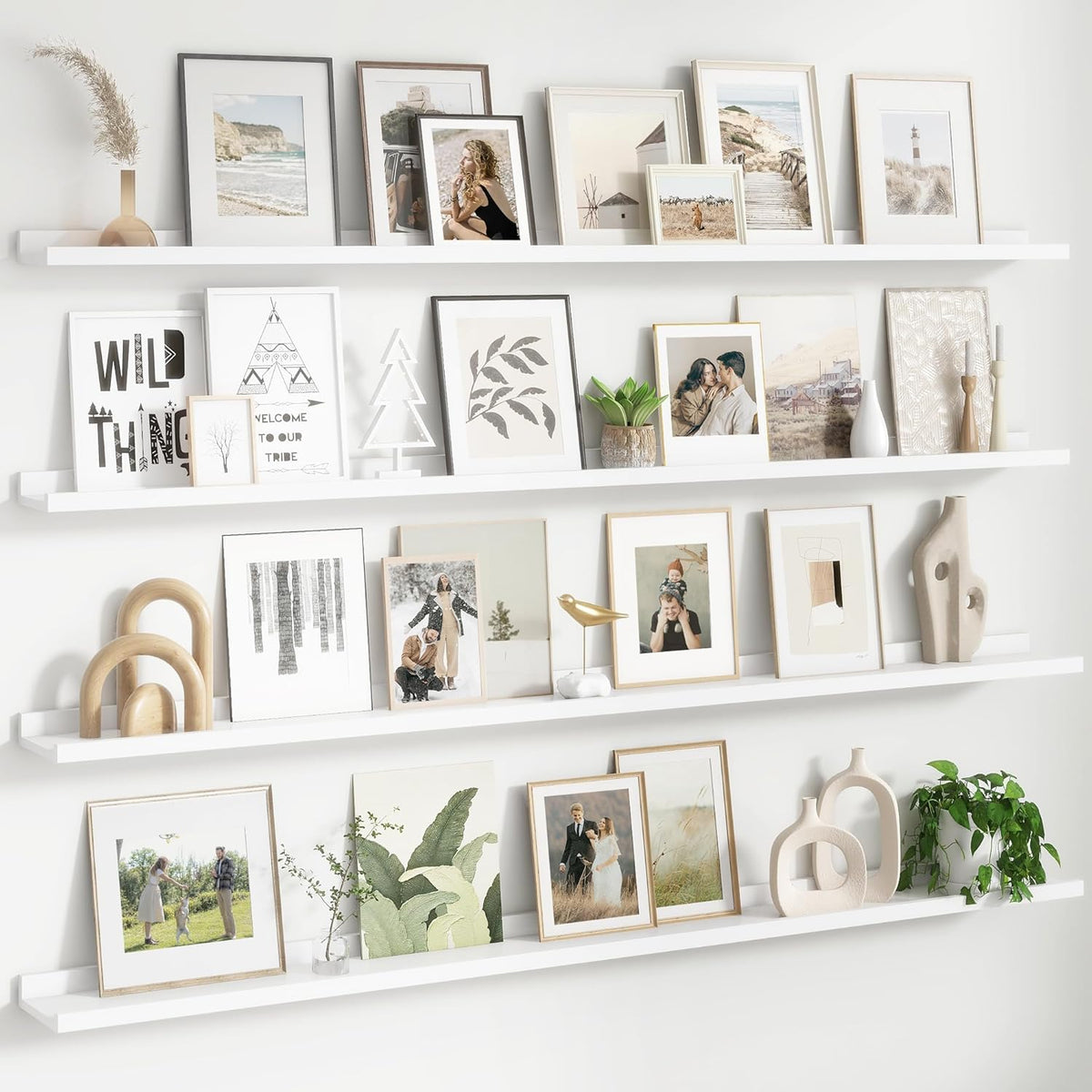 Three white floating picture ledges mounted vertically filled with framed photos and decor.