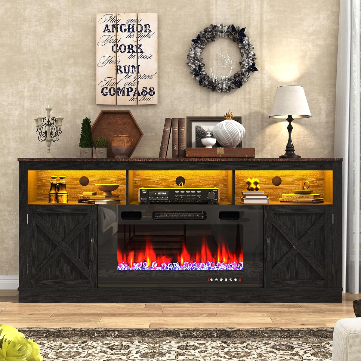 Black farmhouse console straight-on with warm-lit open cubbies, RGB-style flame display and decorative items on top.