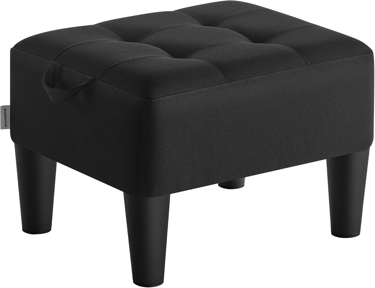 Black fabric tufted square ottoman with small side handle tag and four black tapered legs, angled left.