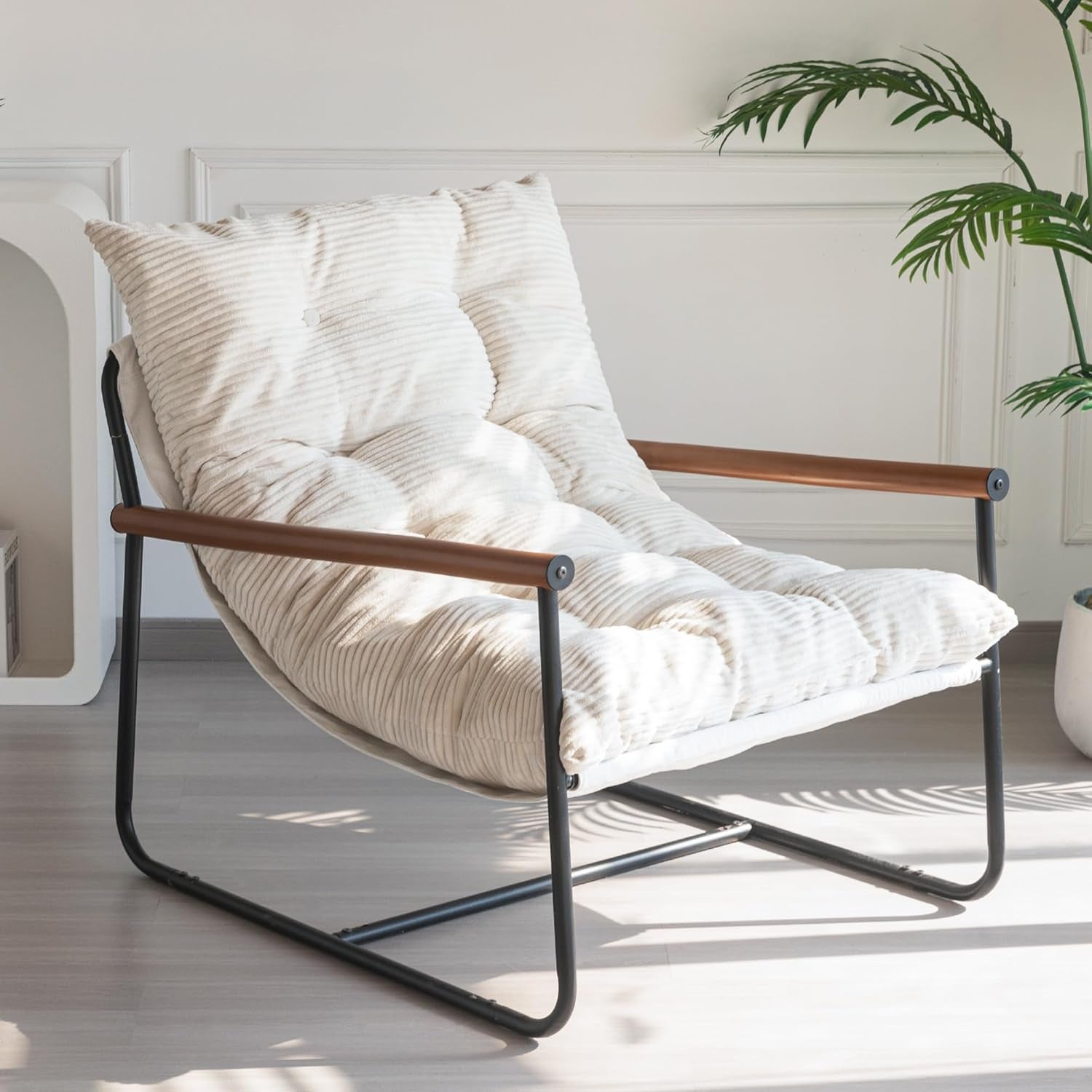 Three-quarter view of a cream corded cushion chair with black metal frame and wooden armrests