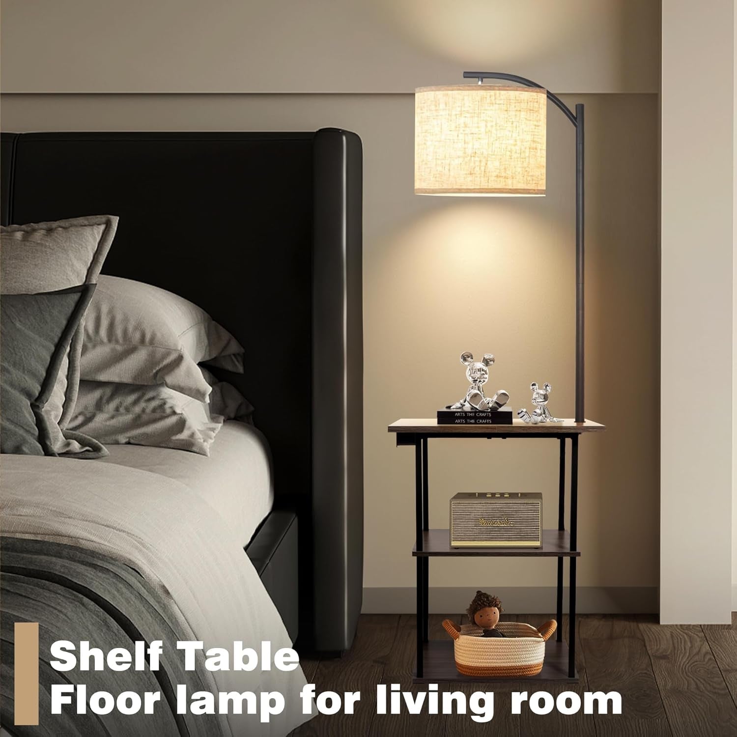 Styled bedroom scene with the floor lamp side table beside a bed illuminating the linen shade
