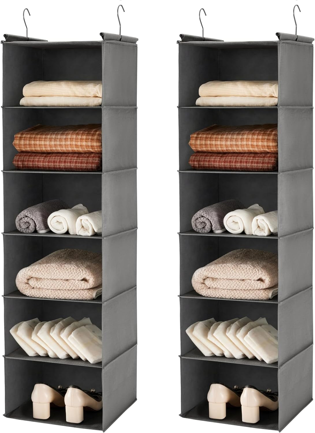 Two light-gray hanging organizers side by side, each holding folded blankets and shoes