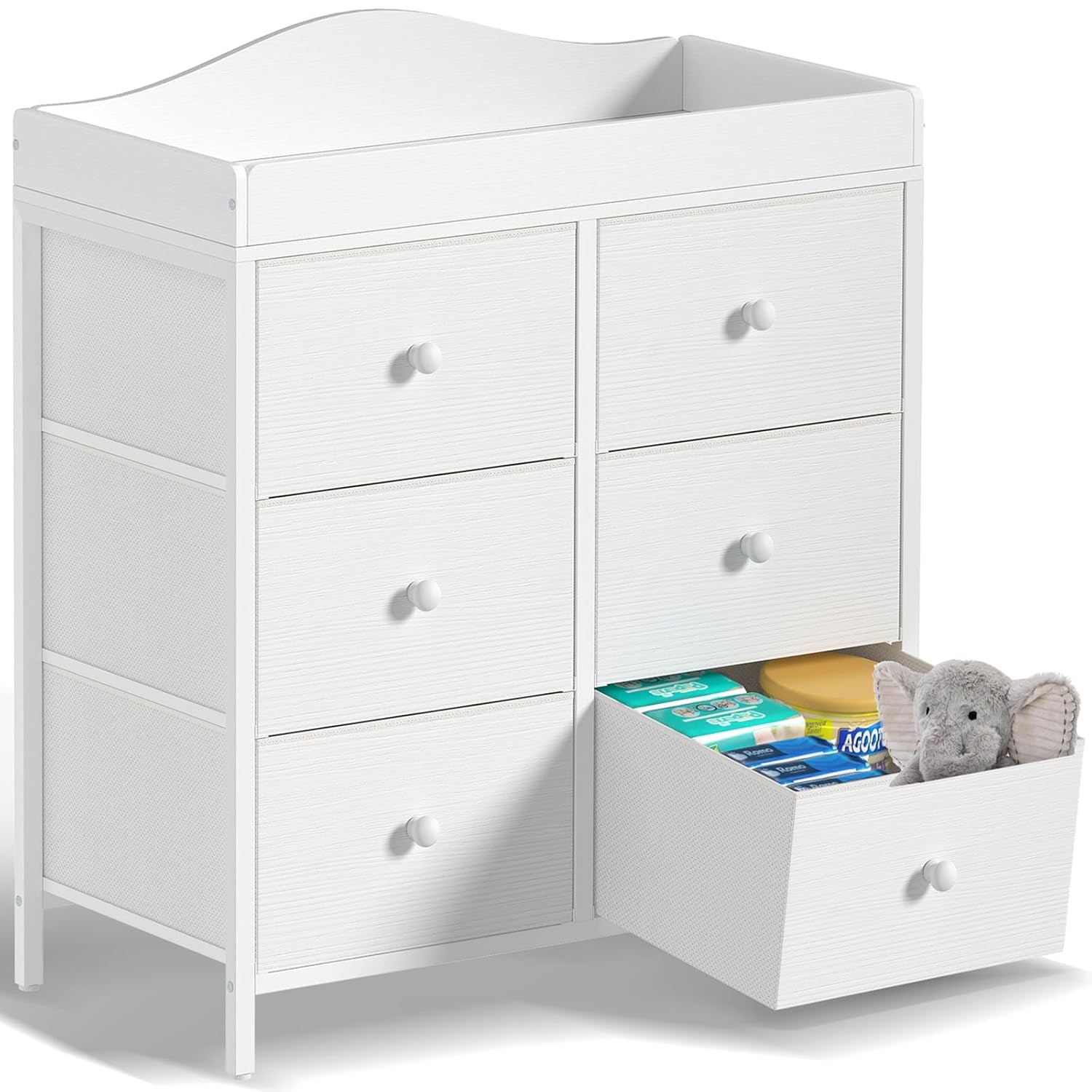 Front view of white changing dresser with the lower-right fabric drawer open showing wipes and a plush elephant.