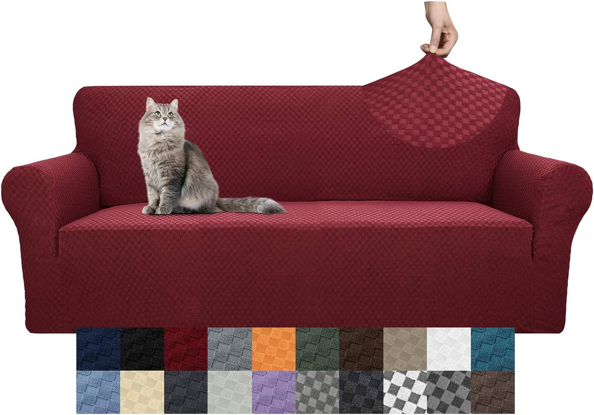 Burgundy textured sofa cover on a three-cushion couch with a gray cat sitting on the cushion and a hand lifting the back