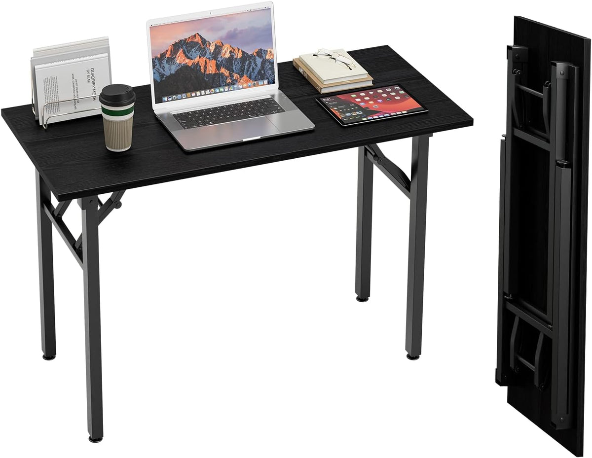 Black wood-grain desk styled with laptop, papers and coffee, folded desk section shown upright at right