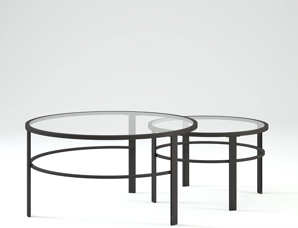Low-angle three-quarter view of two nesting tables on a soft gray gradient backdrop, highlighting the circular frame detail.
