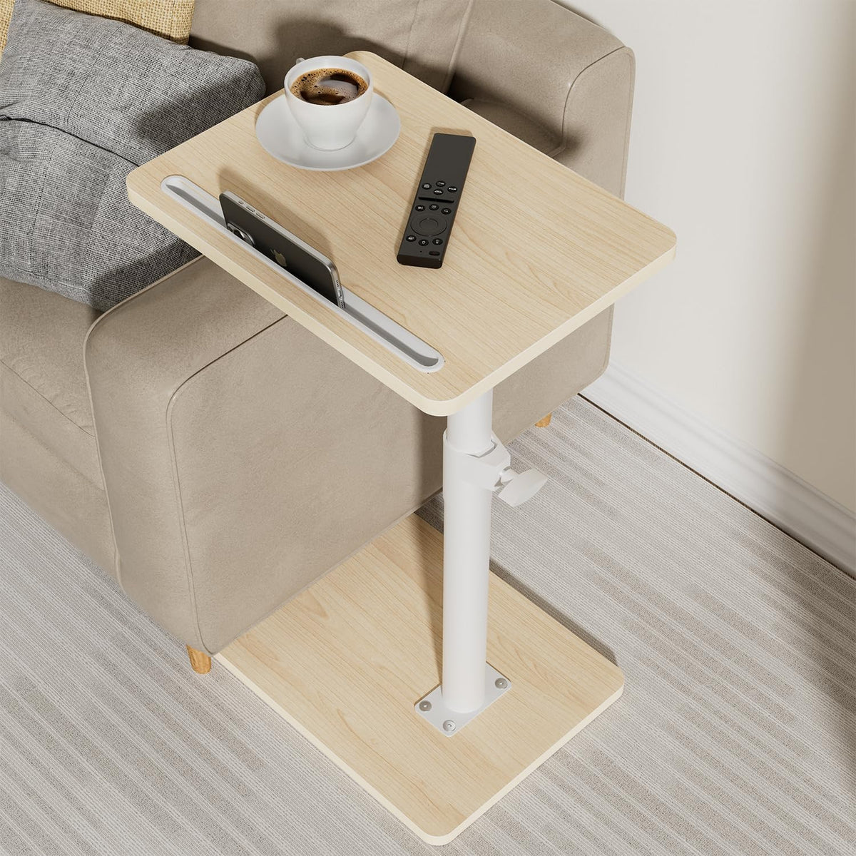 Close view of a light wood tray table showing phone slot, cup, and height adjustment knob.