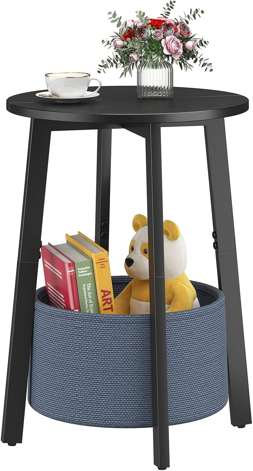 Black round side table with blue cloth storage basket filled with books and a yellow teddy bear
