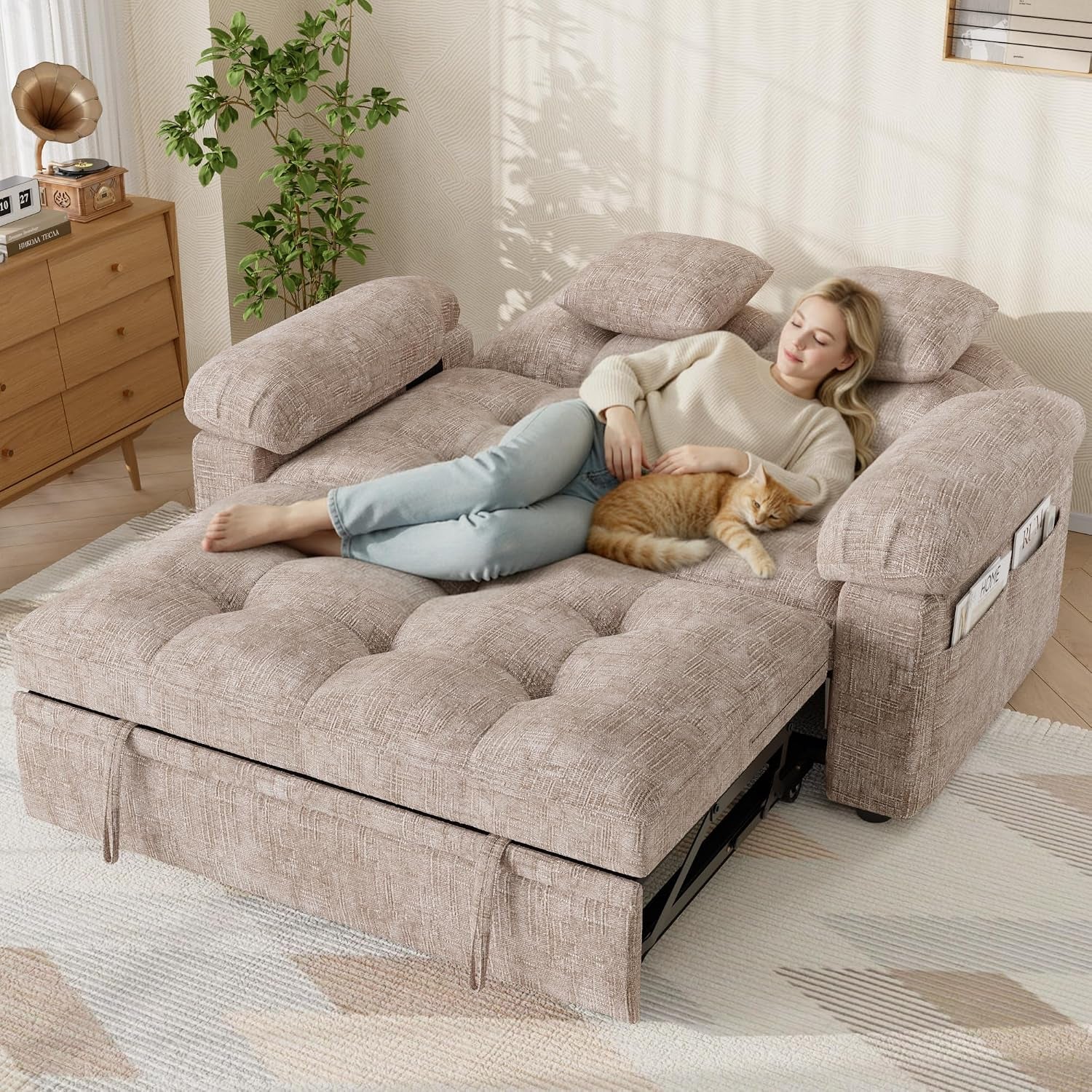 Top view of the loveseat converted to bed with person and cat lying on tufted chenille surface