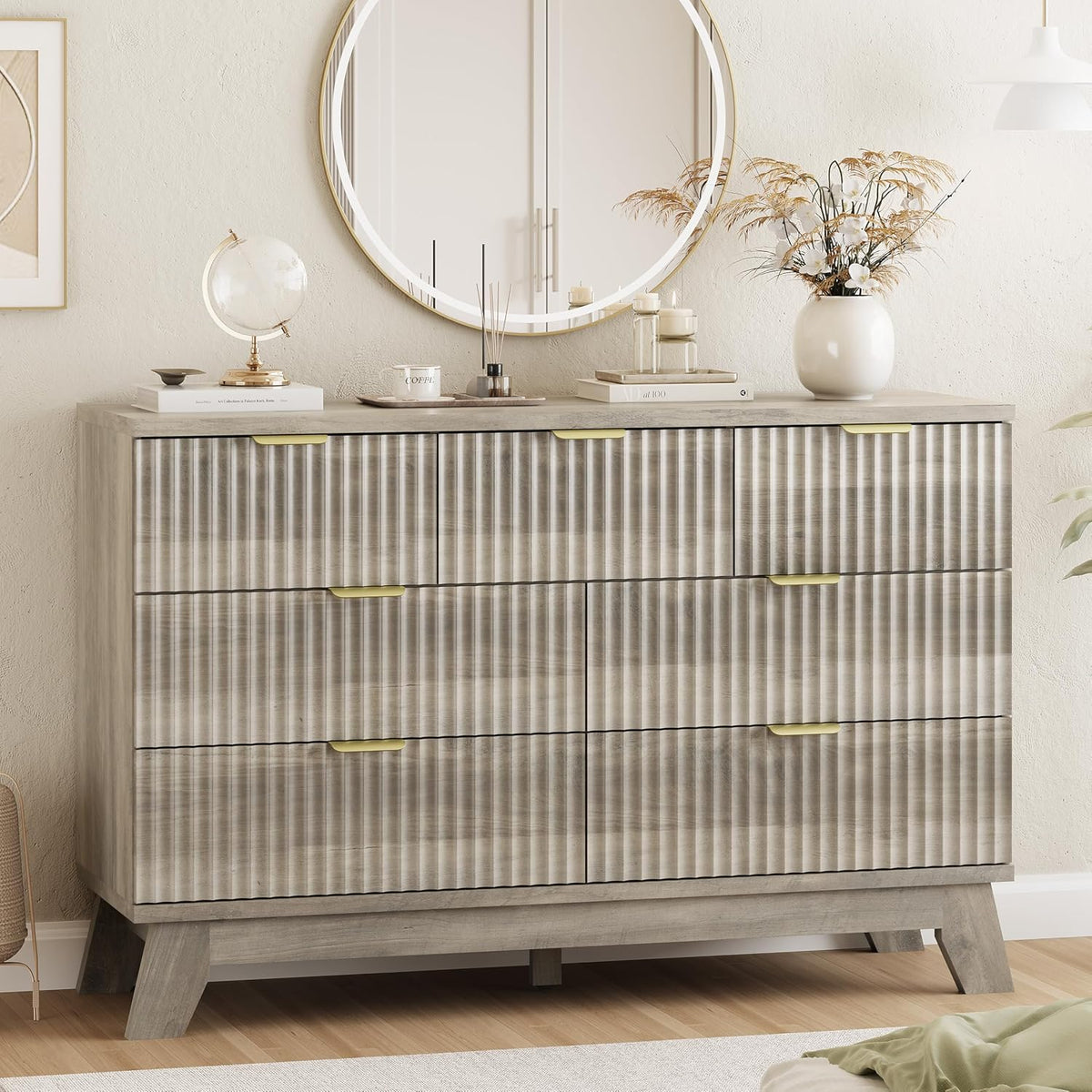 Mid-height wave-panel dresser in weathered gray with round mirror and decorative vase on top