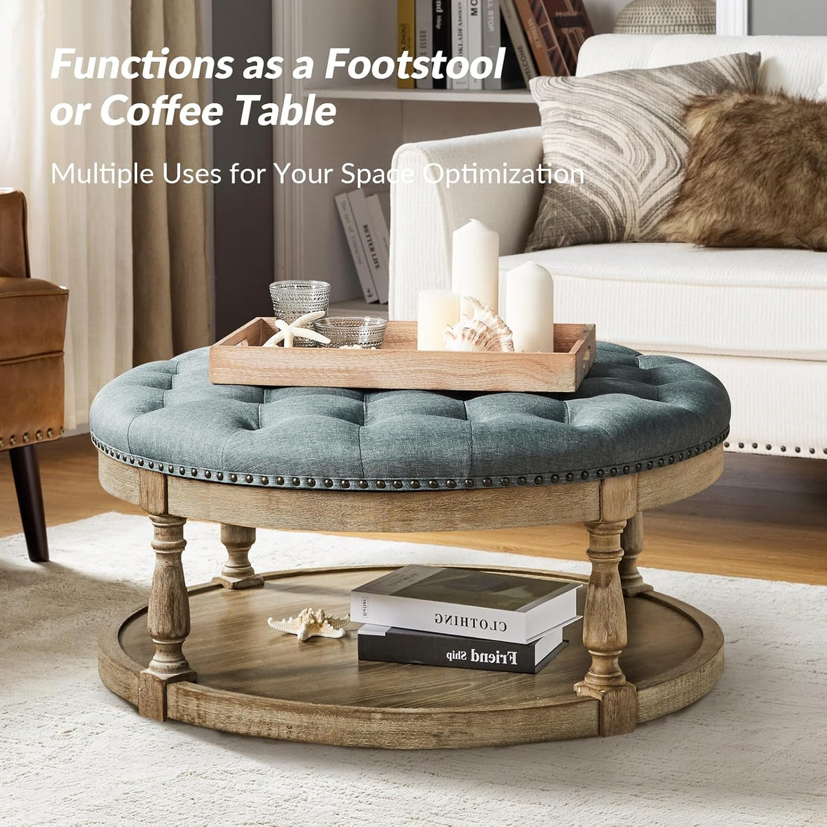 Styled living room scene showing round blue tufted ottoman coffee table with lower shelf and books displayed underneath