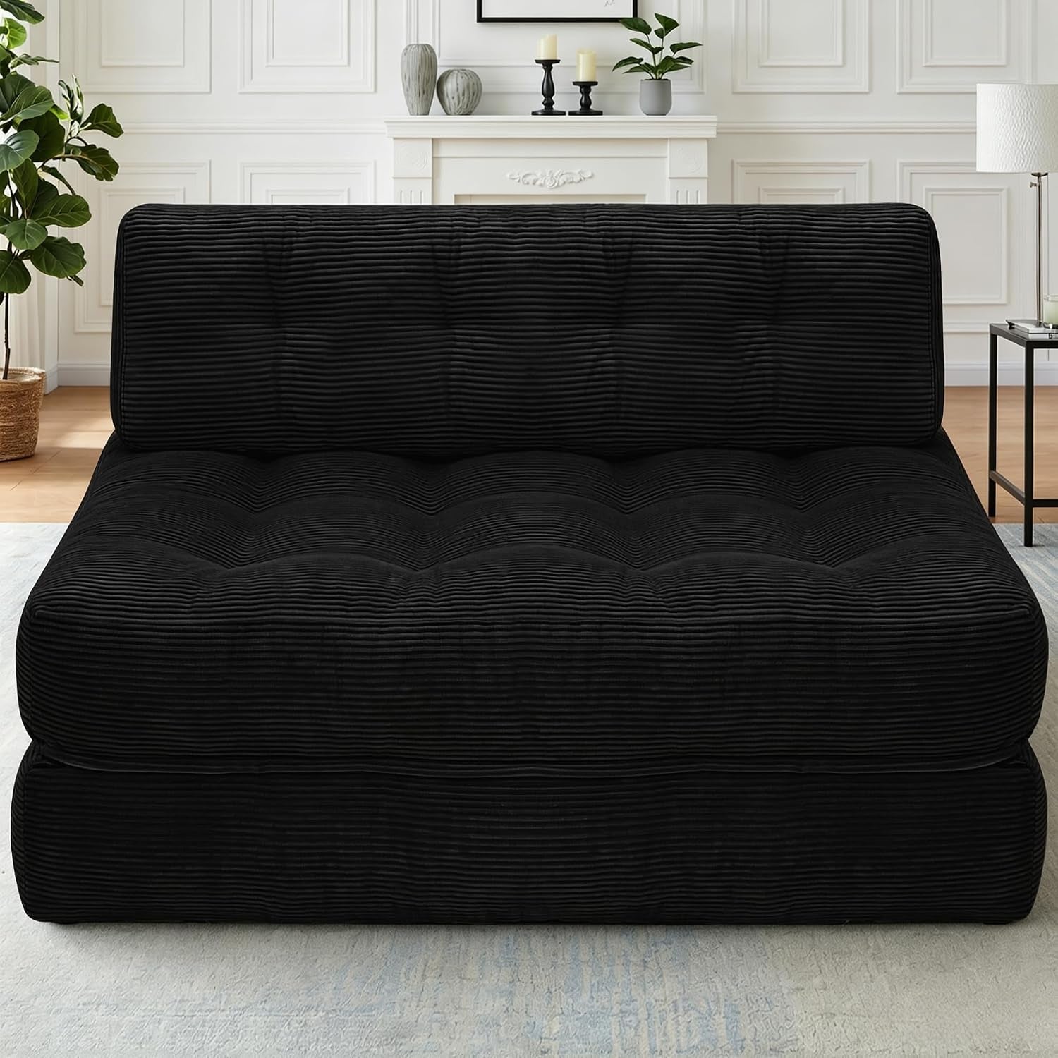 Front view of a black ribbed-corduroy convertible sofa folded into a low sofa position.