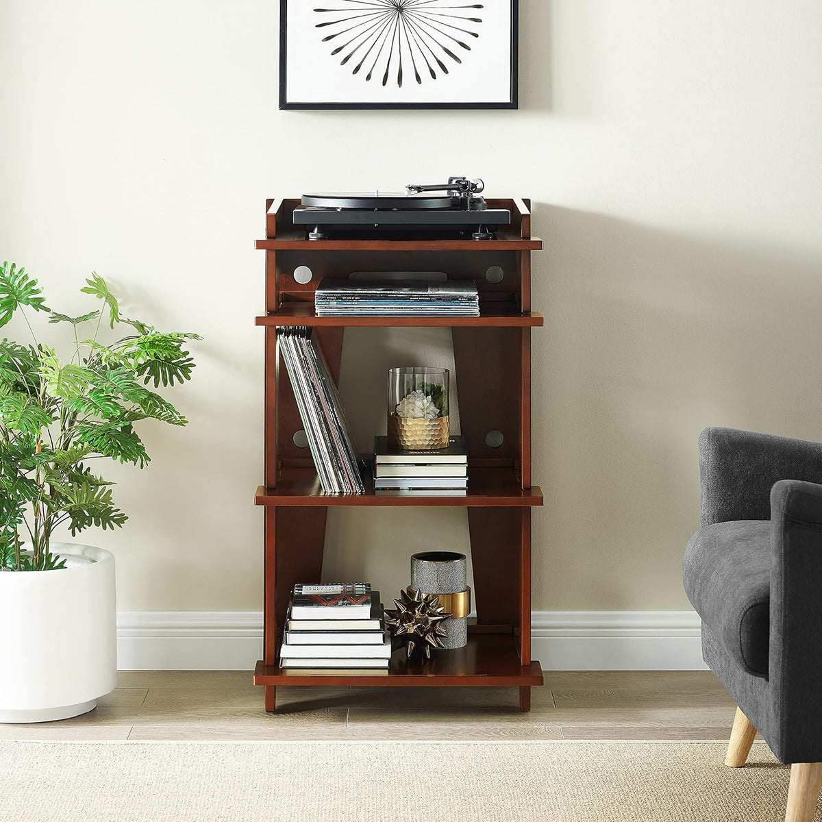 Mahogany record player stand styled in a living room against a light wall with plant and sofa nearby.