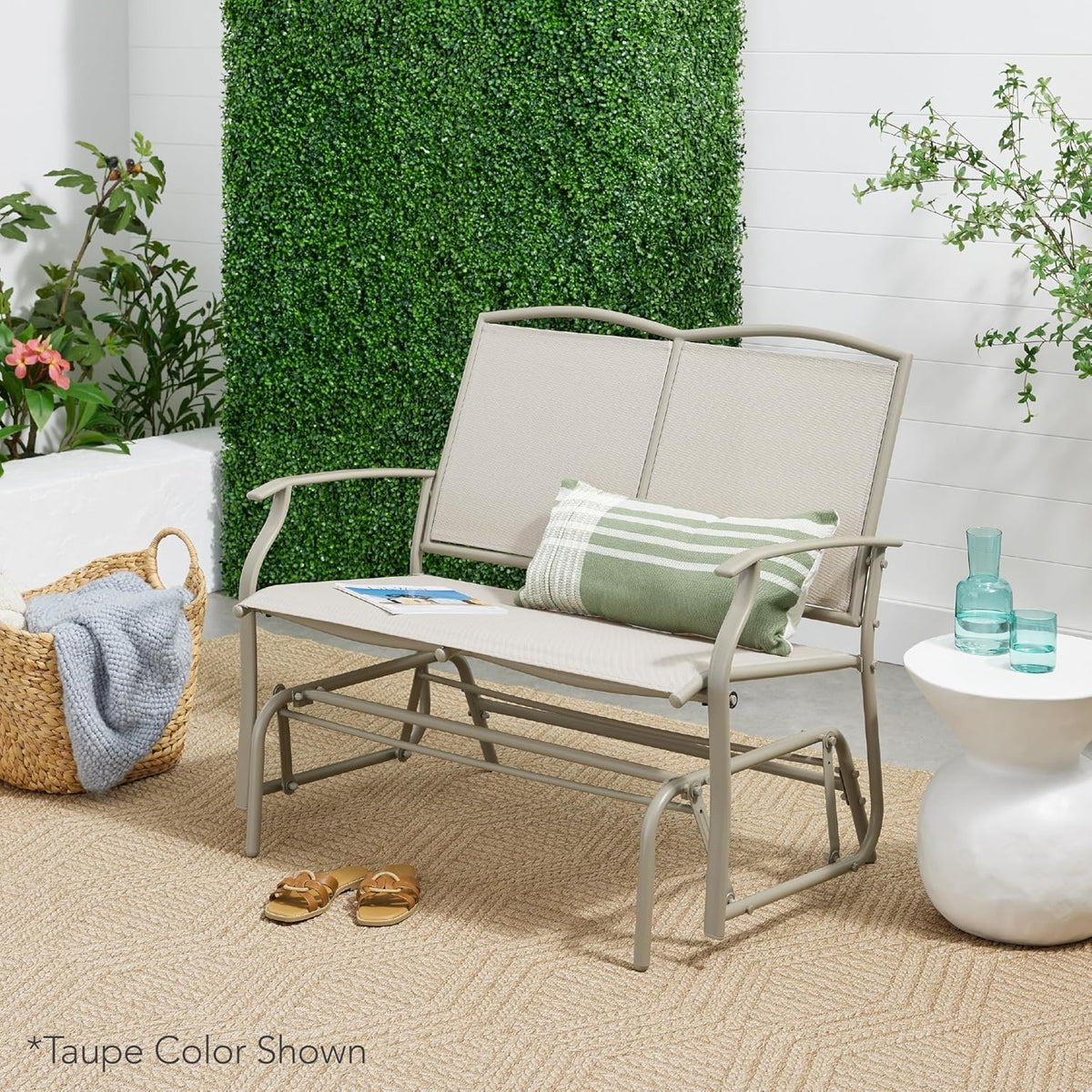 Taupe two-seat gliding bench staged on a patio with cushions