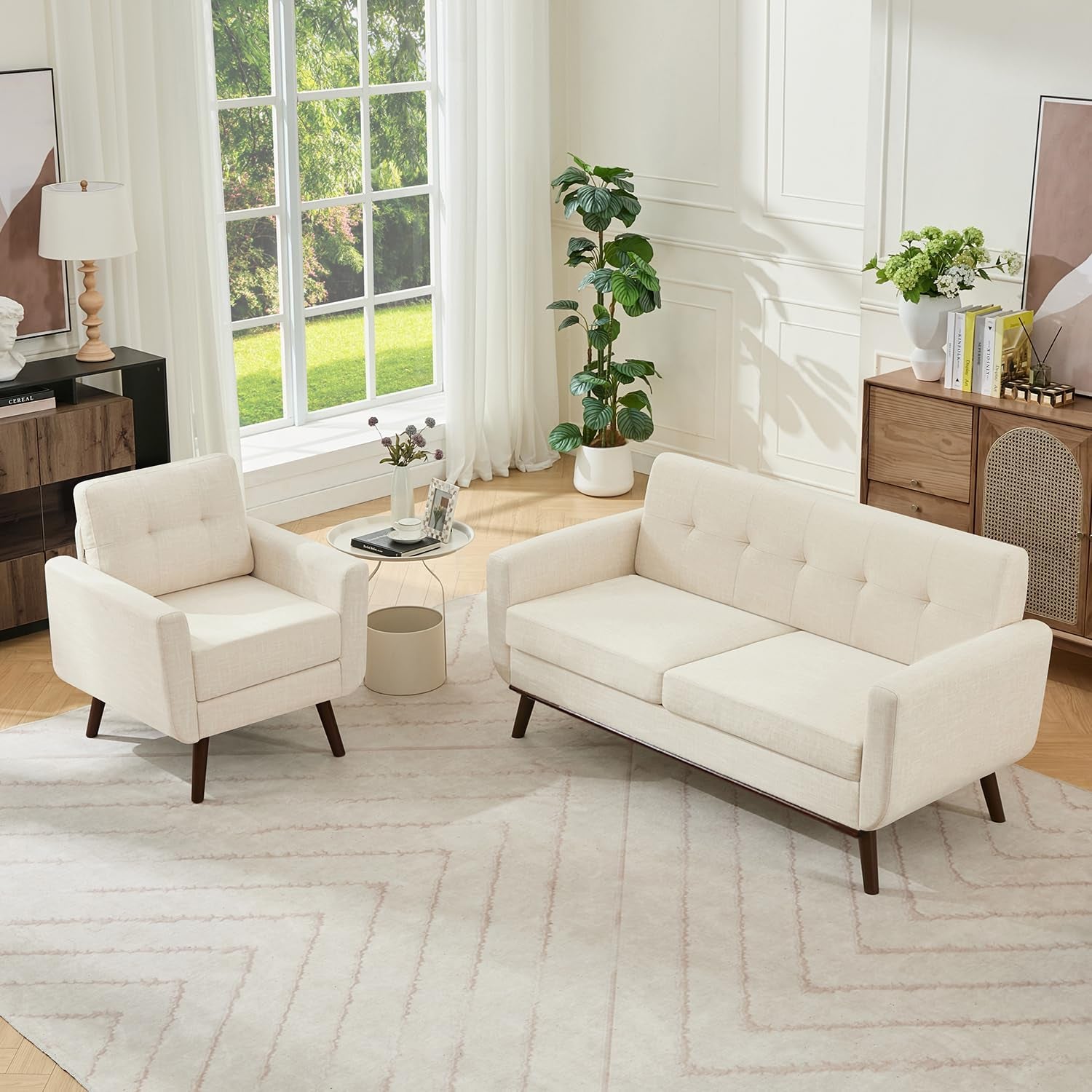 Beige tufted loveseat and matching armchair in a bright living room with large window