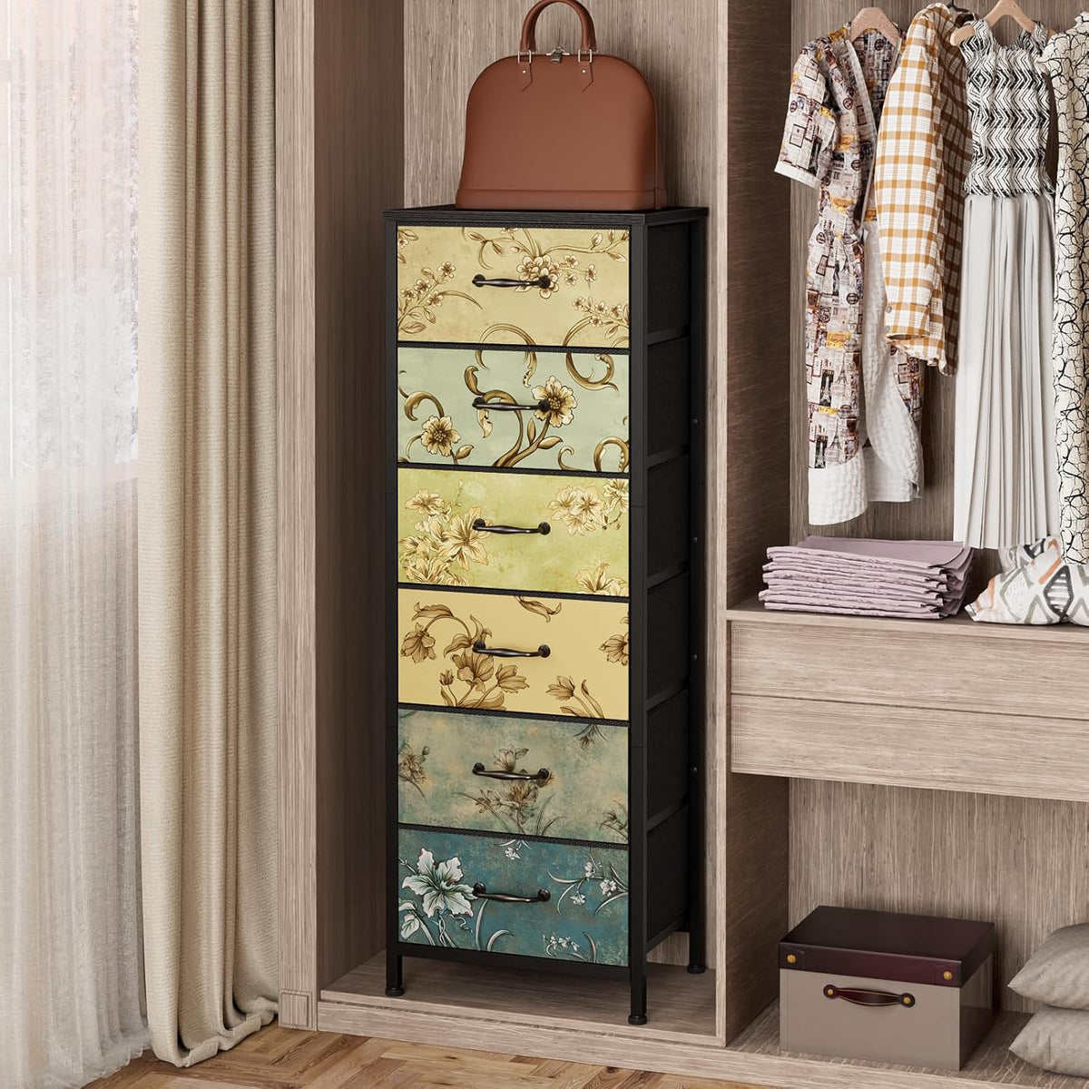 Tall six-drawer fabric dresser with floral drawer fronts placed inside a wardrobe next to hanging clothes and folded linens.