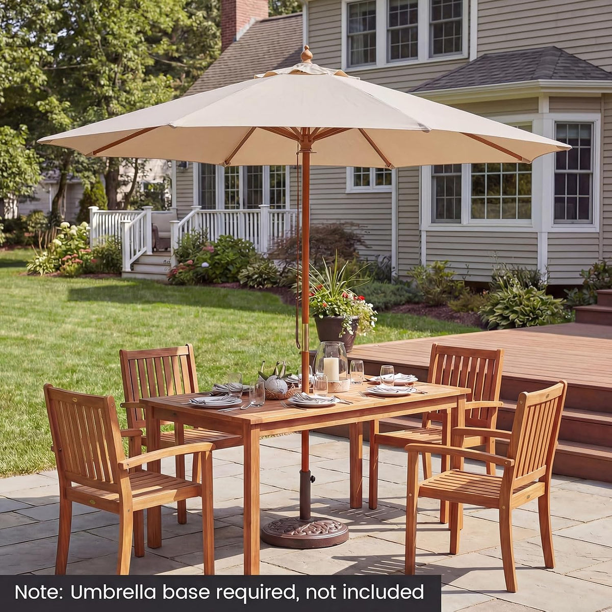 Beige patio umbrella shading an outdoor dining table with wooden chairs on a stone patio