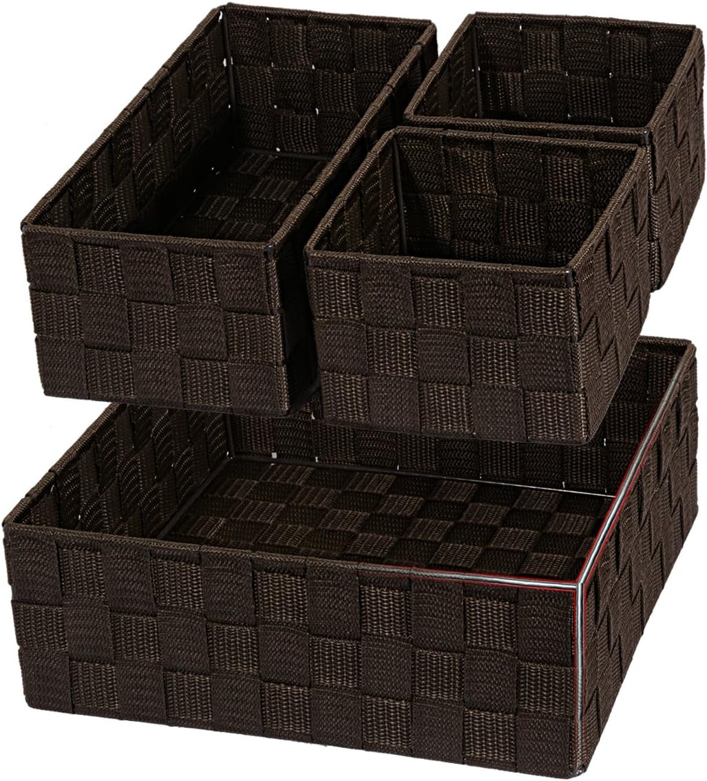 Brown woven baskets arranged with two smaller boxes on top of a larger tray, studio background.