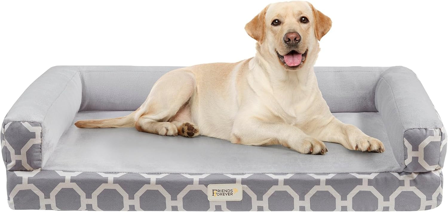 Front view of a grey patterned bolster dog couch with a yellow Labrador reclining on the flat sleep area