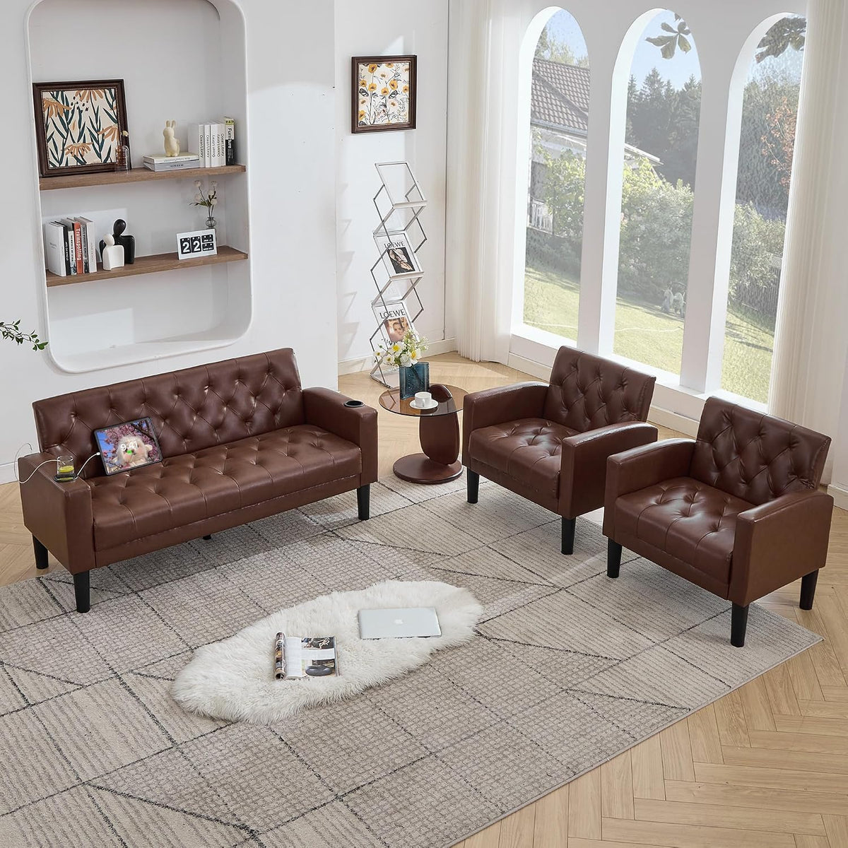 Overhead view of brown tufted loveseat and two armchairs with tablet on the loveseat seat
