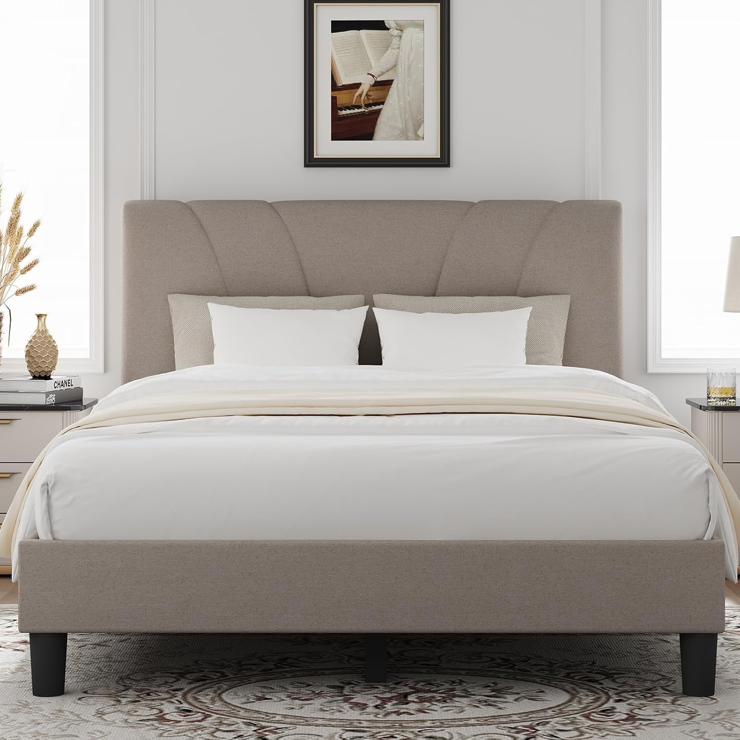 Front view of a taupe upholstered platform bed with a fan-pattern headboard and white bedding.