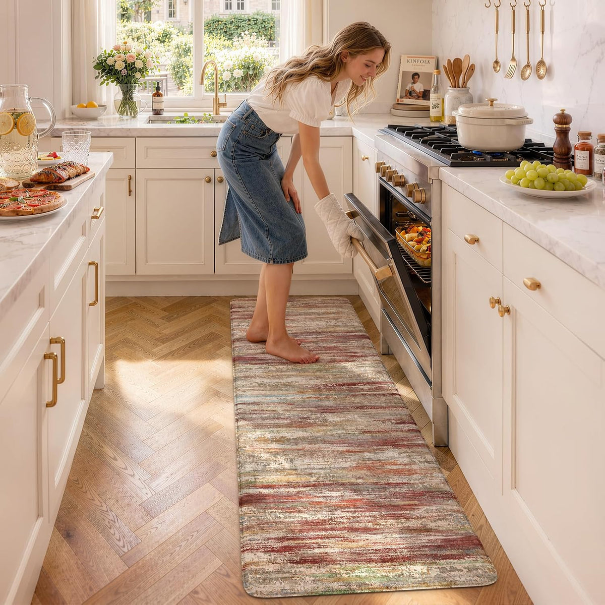 Multicolored striped runner in warm tones with a woman removing a dish from the oven