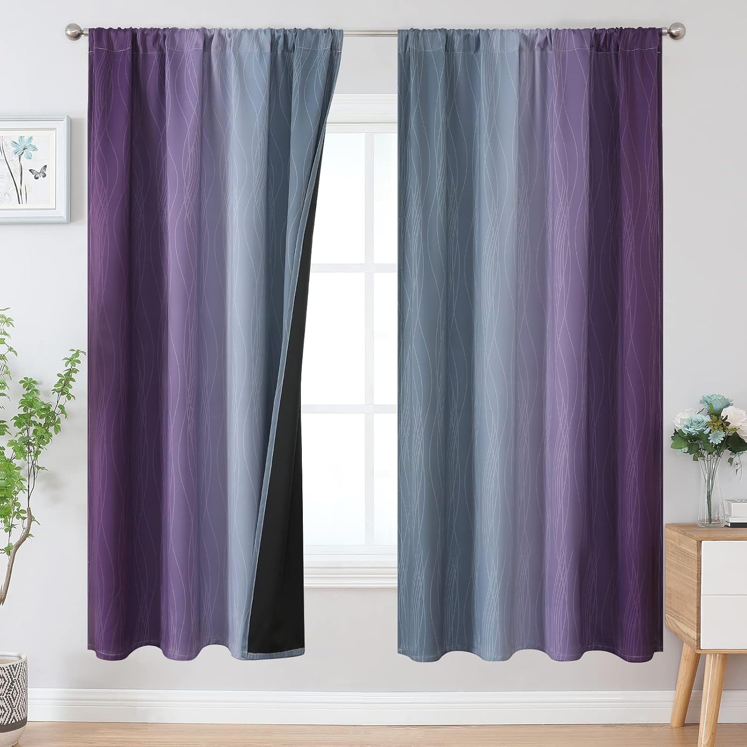 Purple-to-gray ombre curtain panels with subtle white wave pattern framing a window, one panel slightly opened