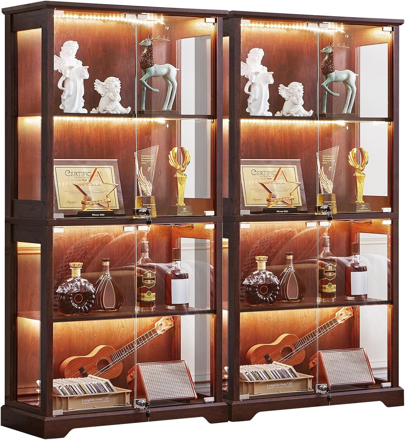 Two dark walnut glass display cabinets side-by-side, each lit and filled with trophies, bottles and a ukulele.