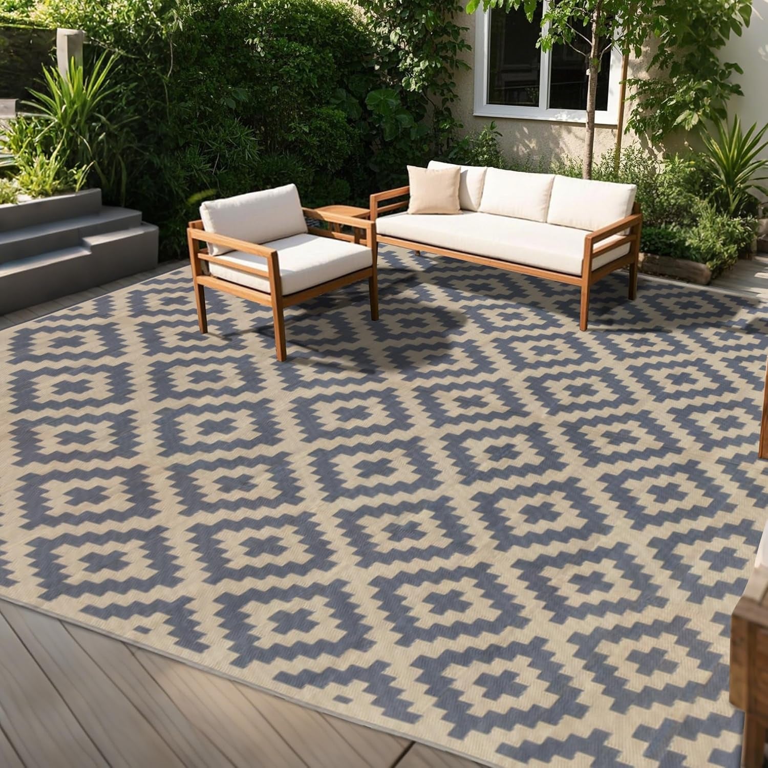 Sunny patio with low wooden seating on a beige-and-gray geometric outdoor rug covering the deck.