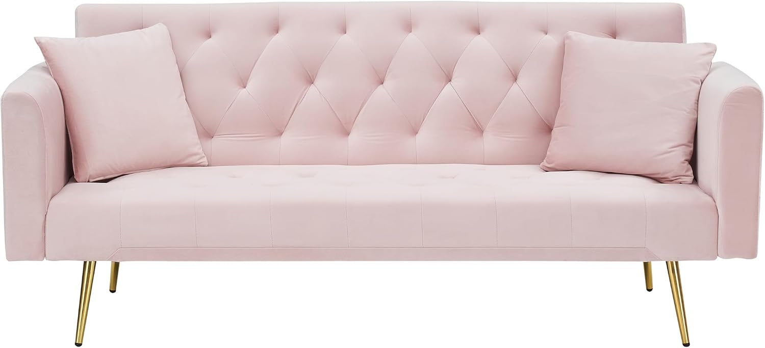 Front view of light pink velvet futon sofa with tufted back and two matching pillows and gold legs