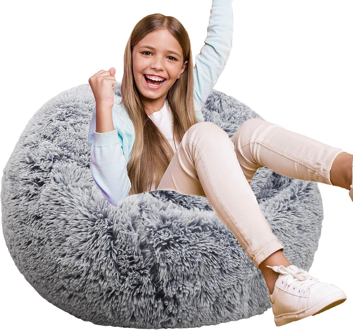 Girl sitting and cheering on a round grey fluffy faux‑fur beanbag chair, cropped on white background