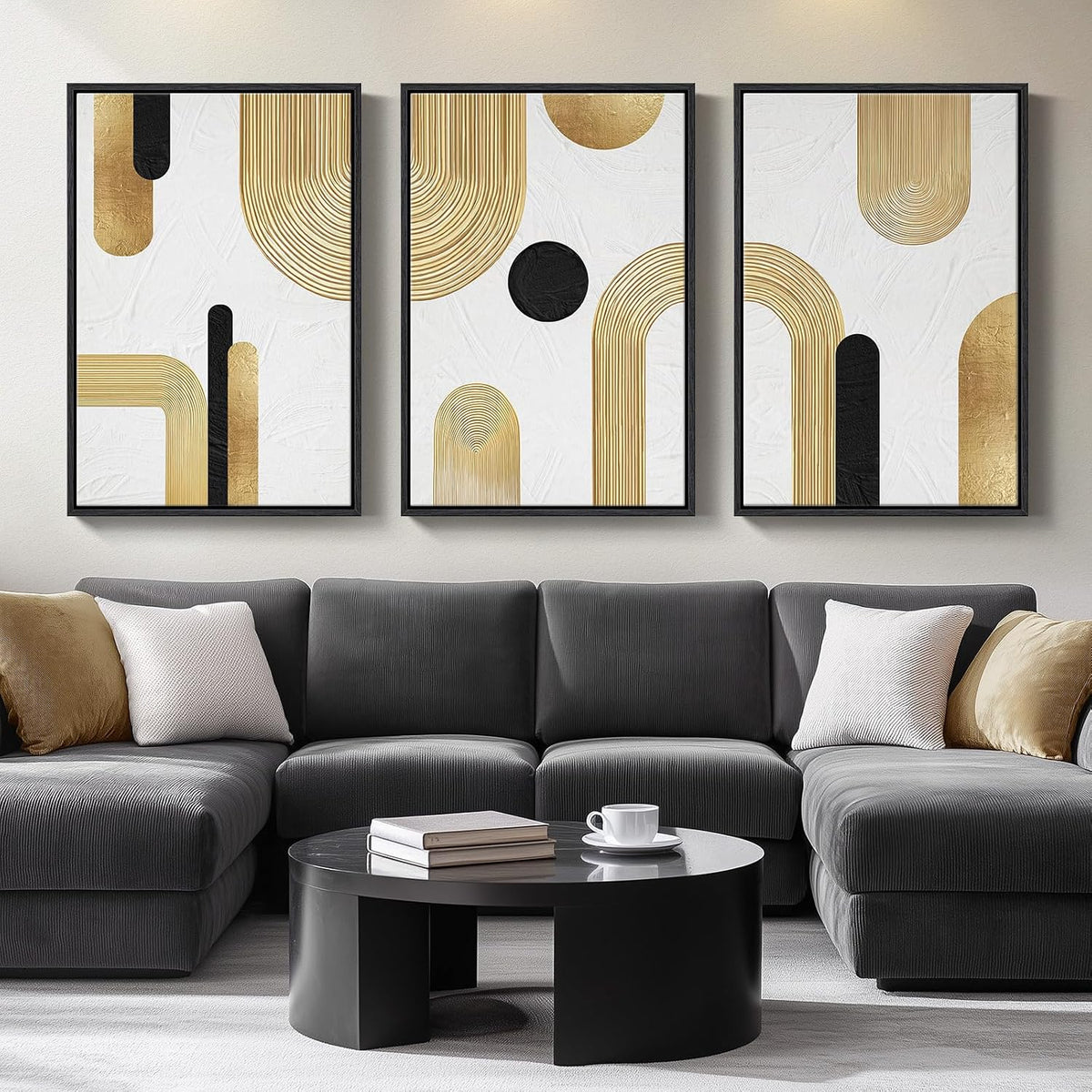 Triptych with gold and black geometric arches on white textured backgrounds above a dark gray sofa.
