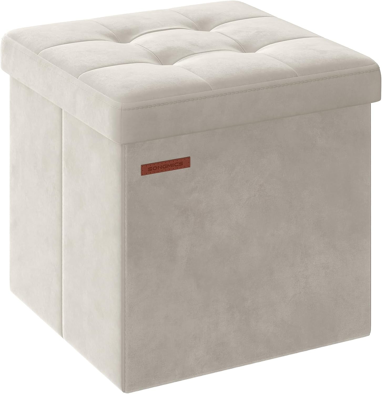 Three-quarter view of a square tufted storage ottoman in light beige faux-leather with stitched edges and a small