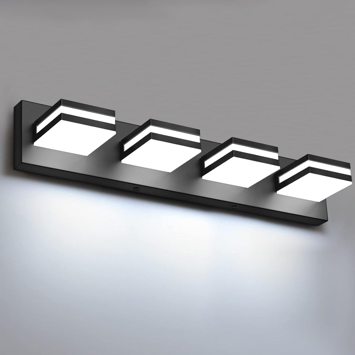 Close angled detail of a black finish vanity light with four square illuminated modules on a black bar.