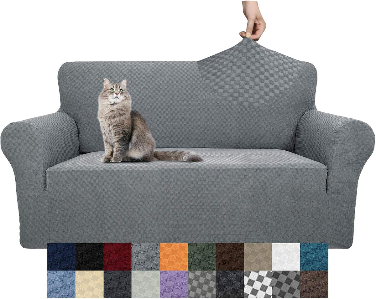 Gray textured stretch slipcover on a two-seat sofa with a cat sitting on the cushion