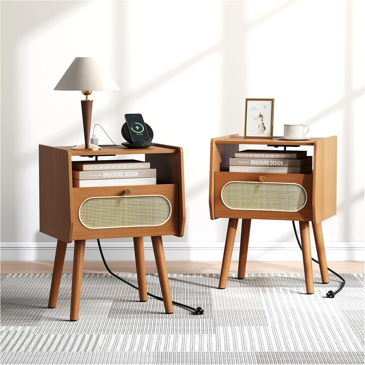 Two medium-walnut round-front nightstands front view with lamp, wireless charger, framed print, mug and visible power cords.