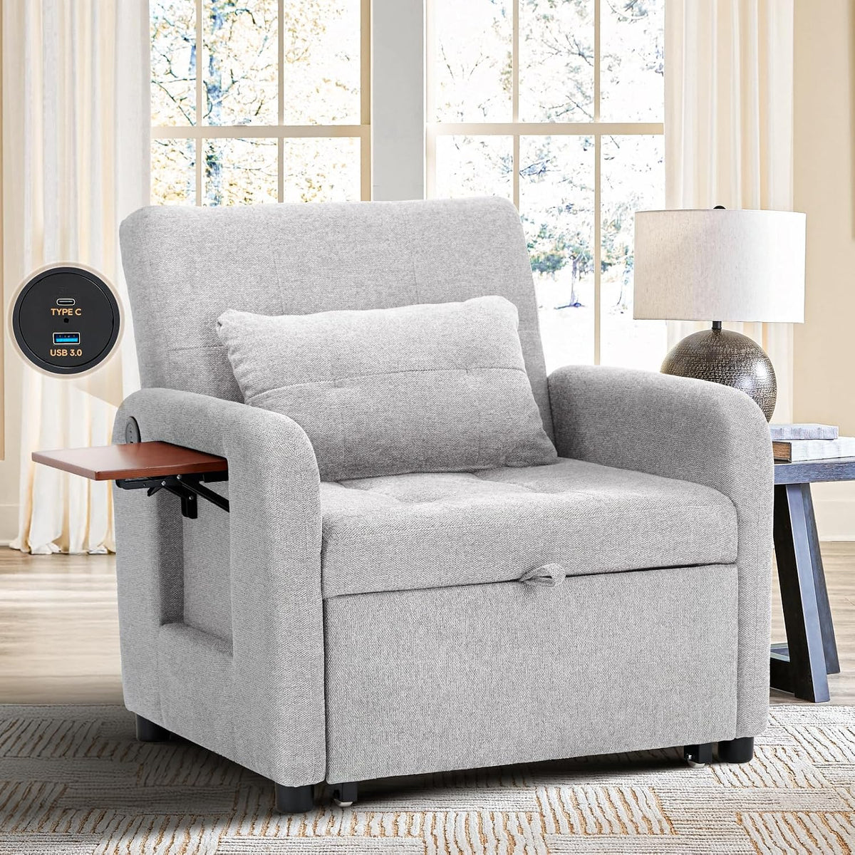 Light gray fabric convertible chair in a sunlit room by a window, small wooden arm table partially pulled out and lumbar
