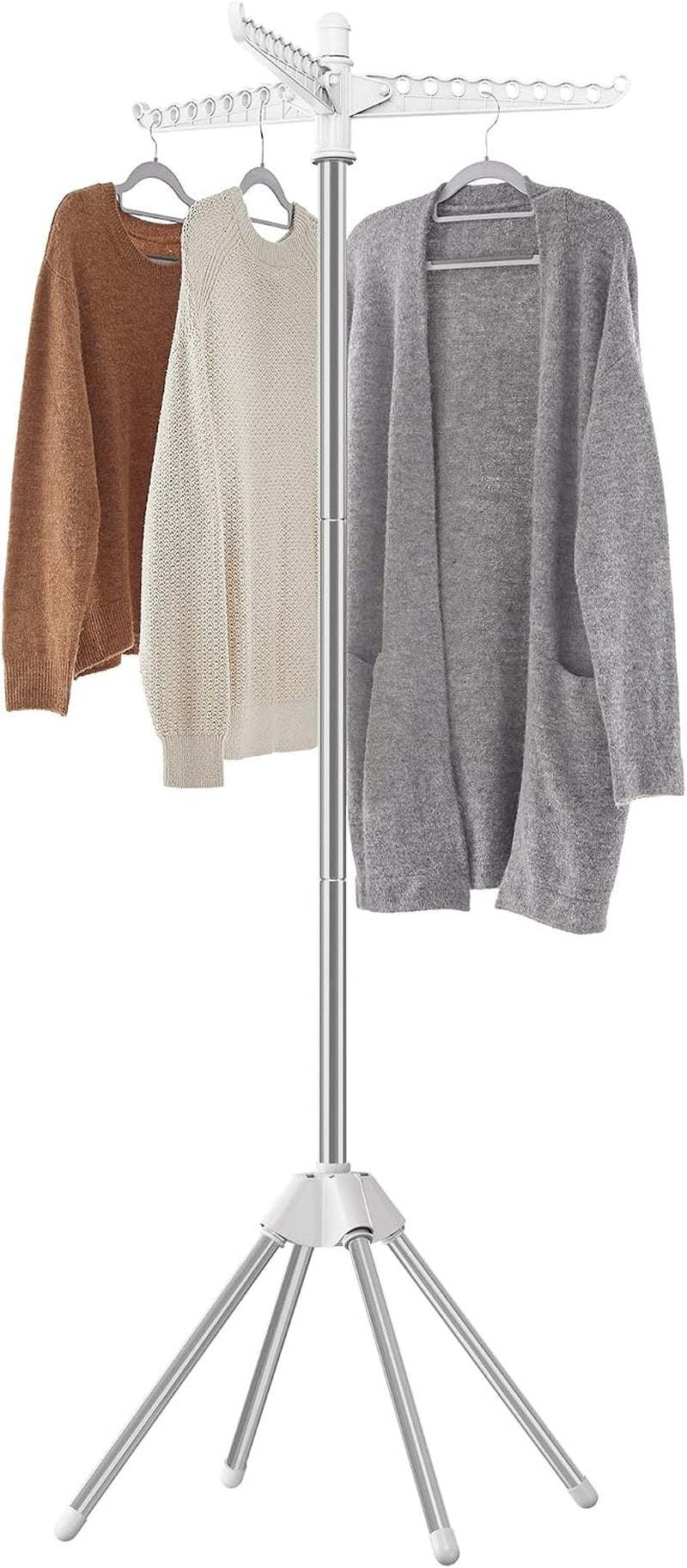 Silver metal drying rack with three arms and five legs, holding three sweaters and a cardigan on hangers.