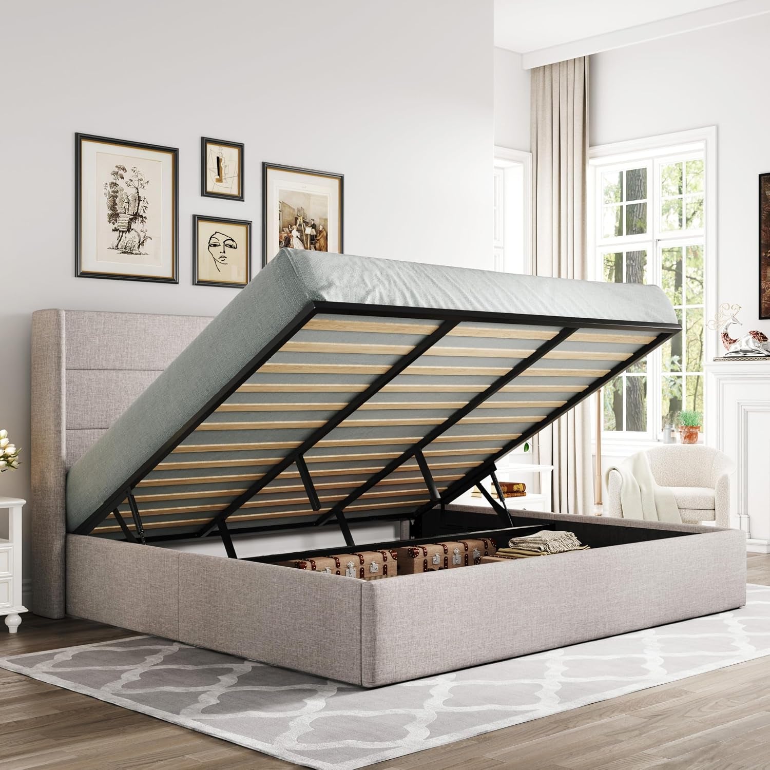Three-quarter view of a light beige upholstered storage bed with the mattress raised to reveal inside storage.
